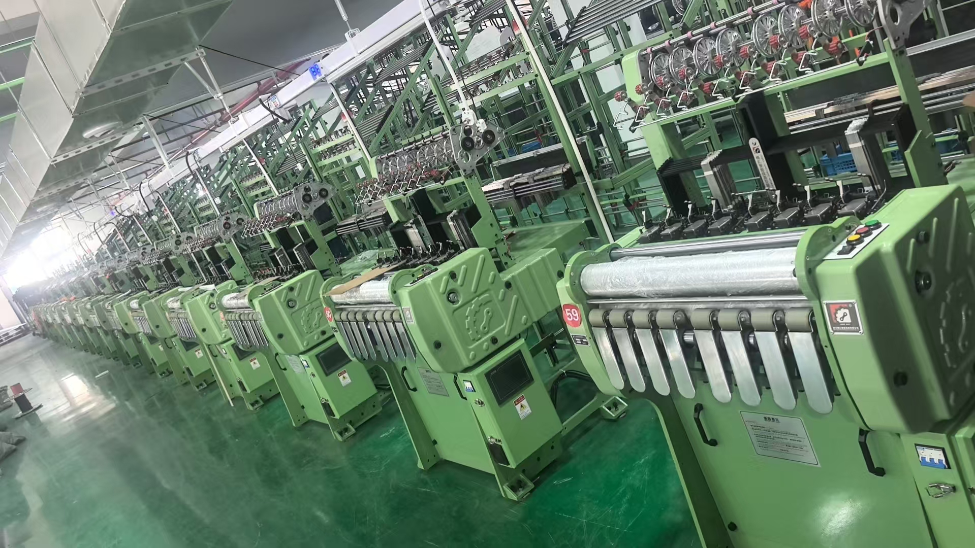 Completed webbing machines arranged on the factory floor
